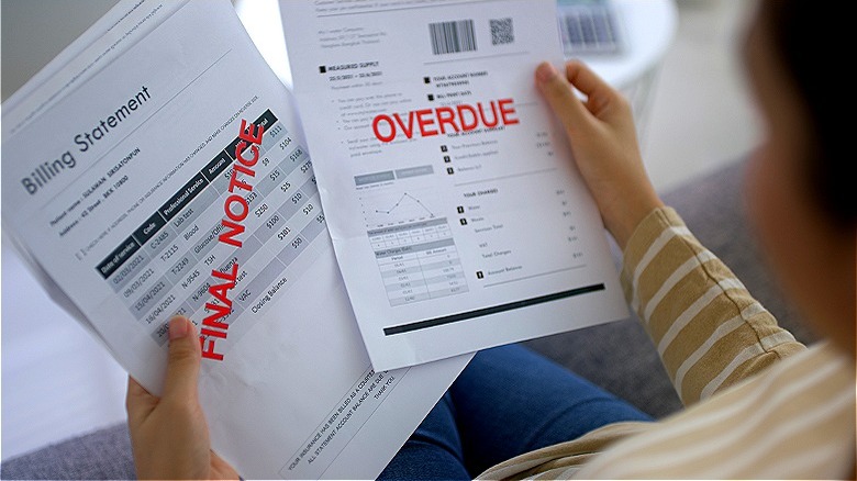 Person holding overdue bills