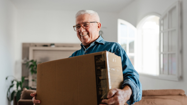 a retiree carrying a box