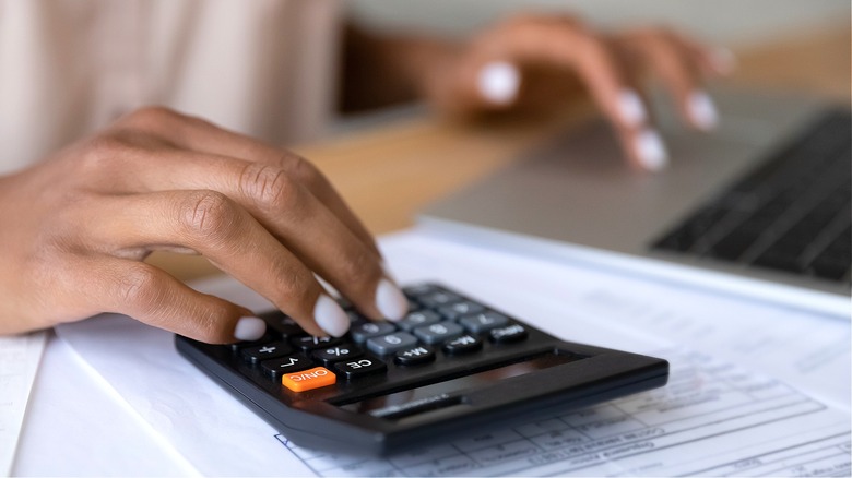 Person doing calculations on computer