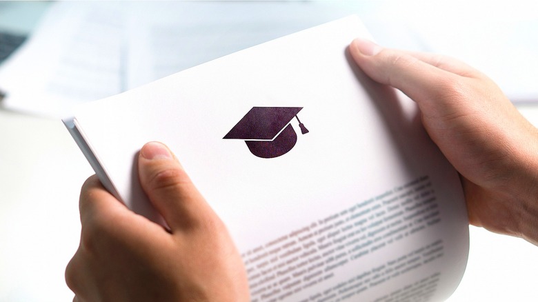 Person holding college grduation paperwork