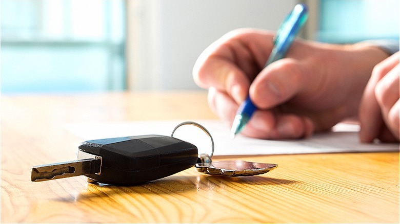 Person signing near car keys