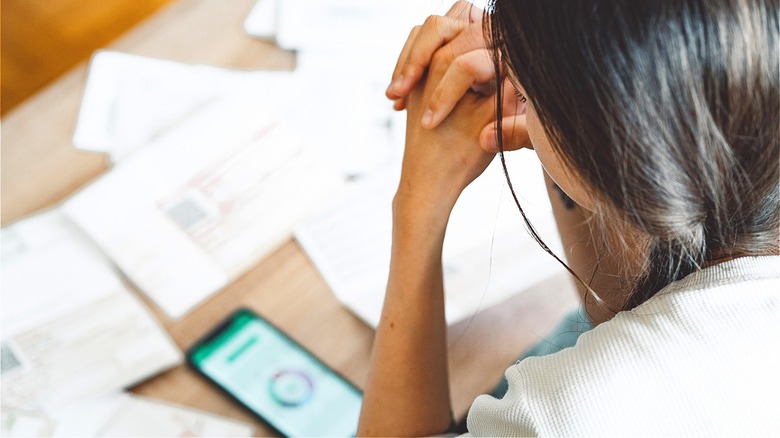Person looking stressed over bills