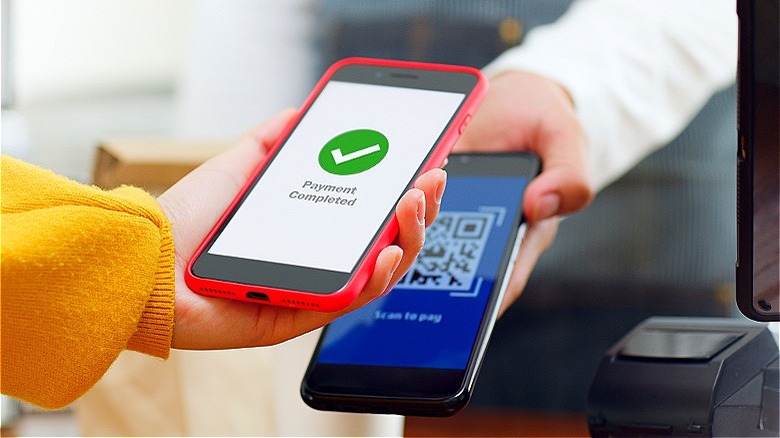 Person making payment via smartphone