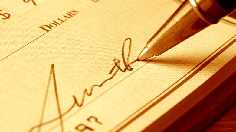 Person handing over a check
