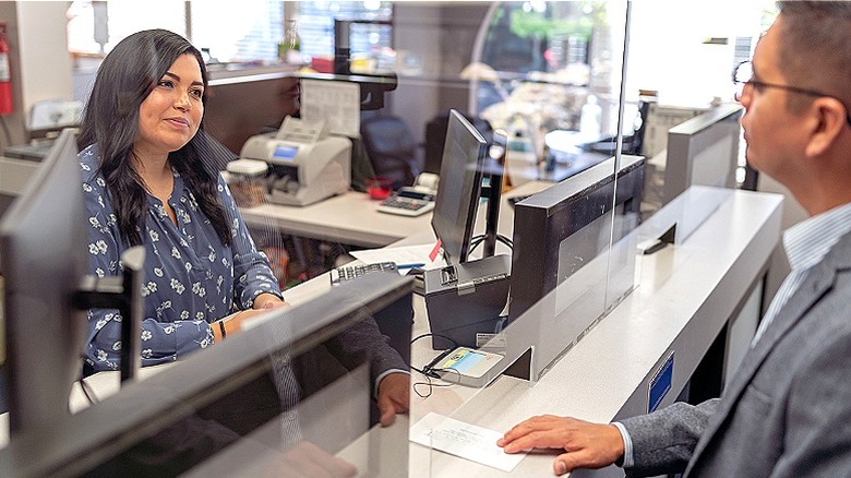 People talking through teller window