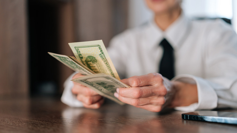 Closeup of a person counting American currency