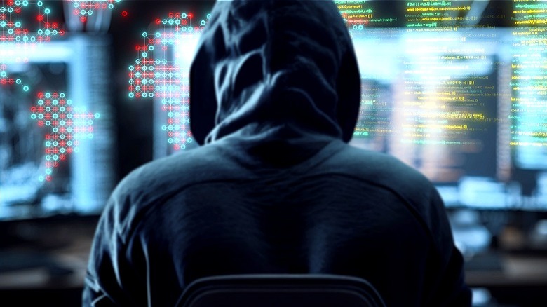 Hacker working on monitors