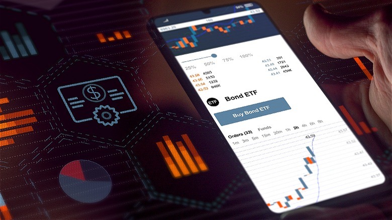 Person holding phone, ETF trading