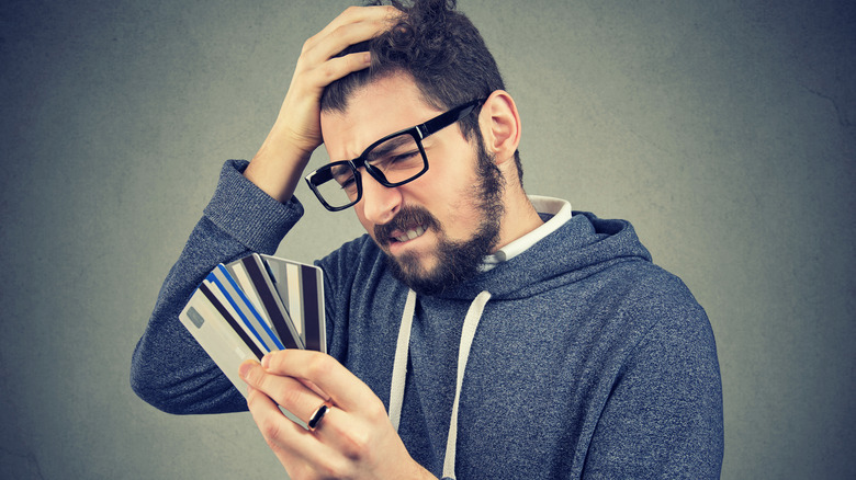 man thinking about credit cards