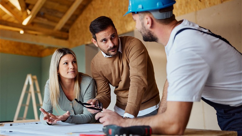 Couple speaking with a contractor