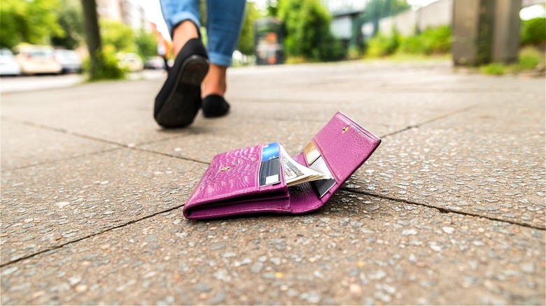 Person walking from open wallet