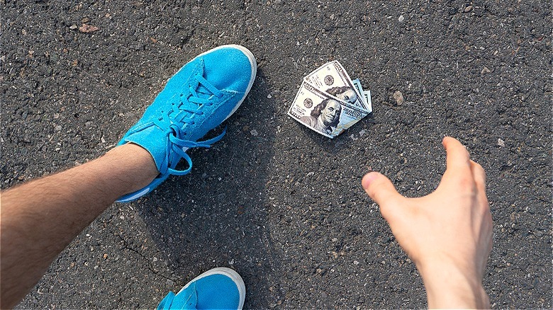 Person finding money on street