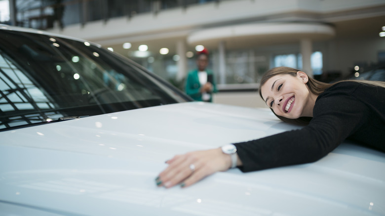 woman hugging a car hood
