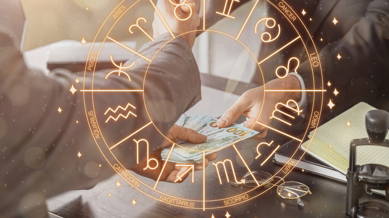 two people exchanging dollar bills with astrology overlay