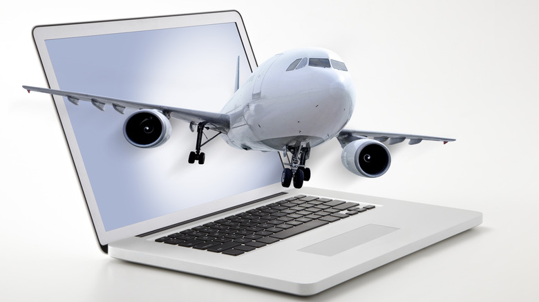 plane flying from laptop computer