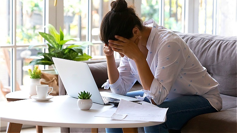 Person at laptop looks worried