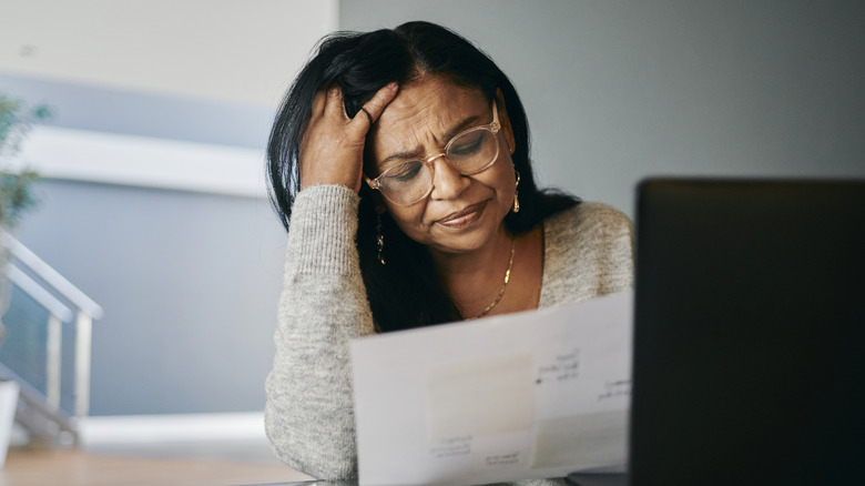 Stressed women looking at documents.