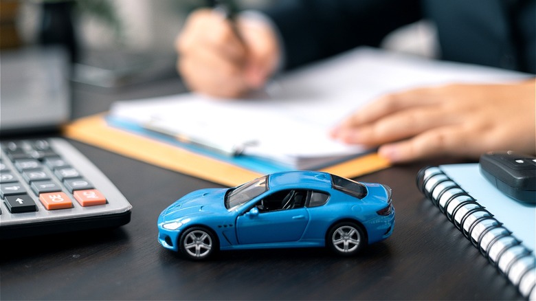 Toy car, auto loan paperwork
