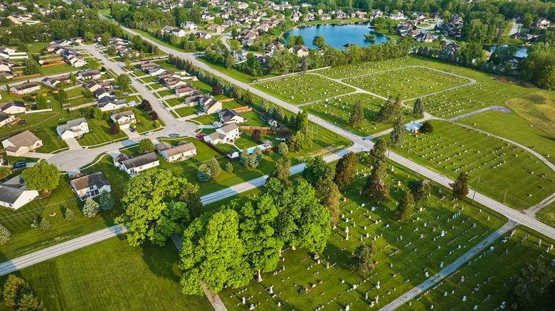 Houses clustered near a cemetery