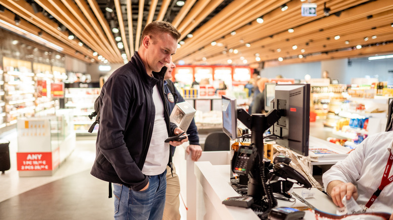 A man at a duty-free store counter