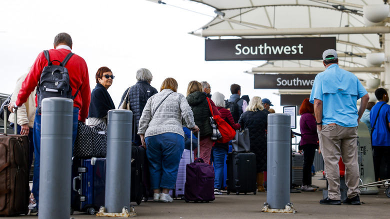 Passengers in line at the Arrivals portion of a Denver Airport terminal