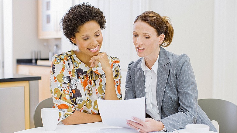People discussing document in home