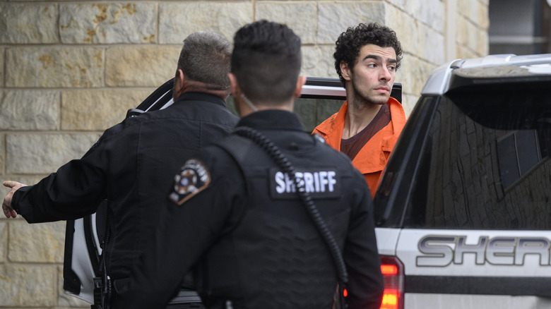 accused murderer Luigi Mangione with police officers