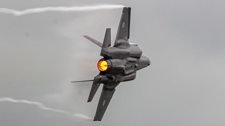 An F-35 in flight against a gray sky