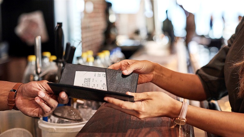 Server handing diner the check