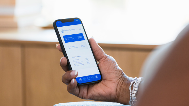 Person looking at account balance on mobile banking app