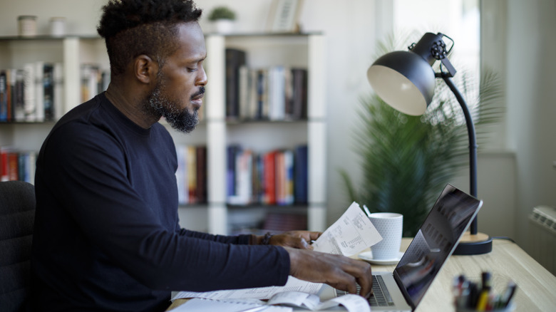 Man looking over bank statements
