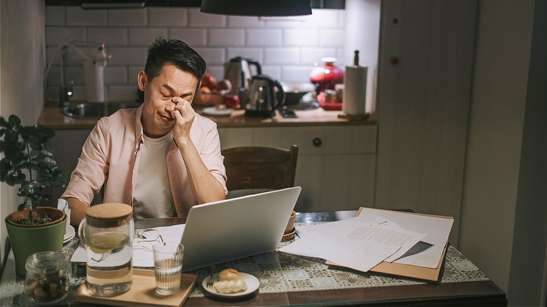 Person frustrated with financial paperwork