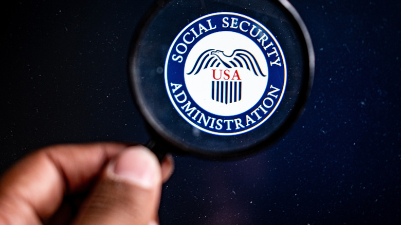 US Social Security Administration logo is seen through magnifying glass