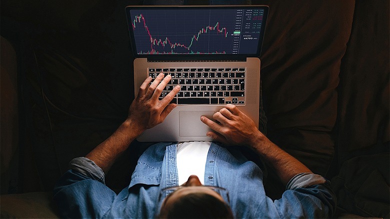 Person trading cryptocurrency on laptop