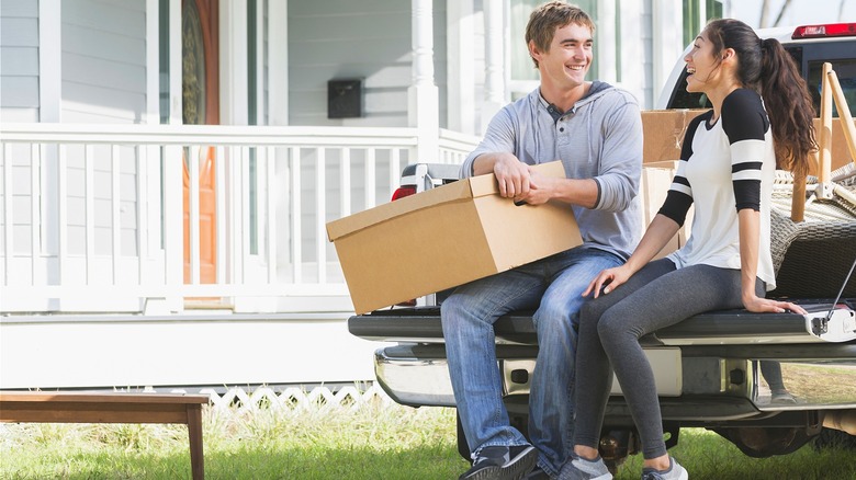 Couple smiling outside new home