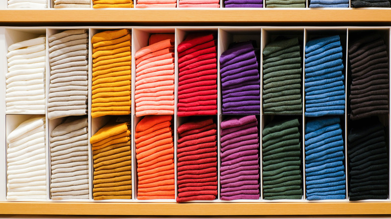 color-organized shelves of shirts