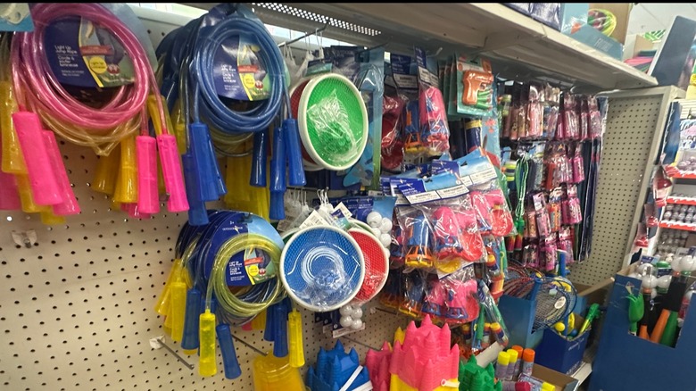 Toy rack at a dollar store with an assortment of plastic toys