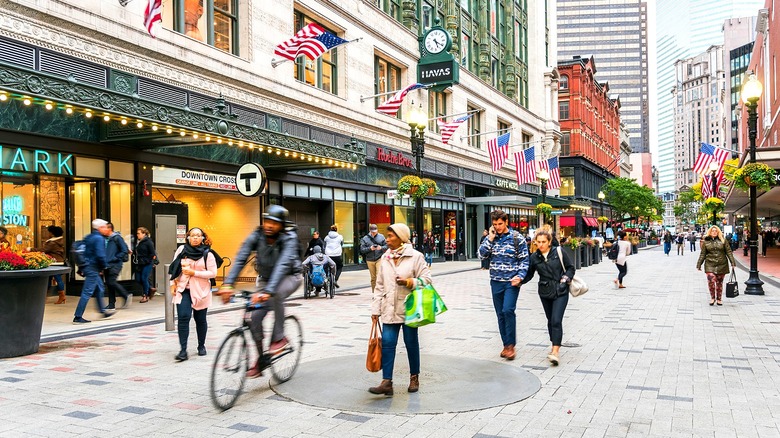 Consumers walking along shops outside