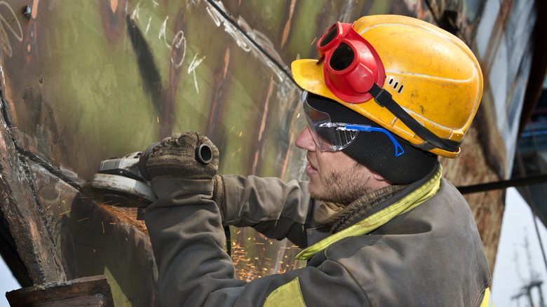 A boilermaker repairing a boiler