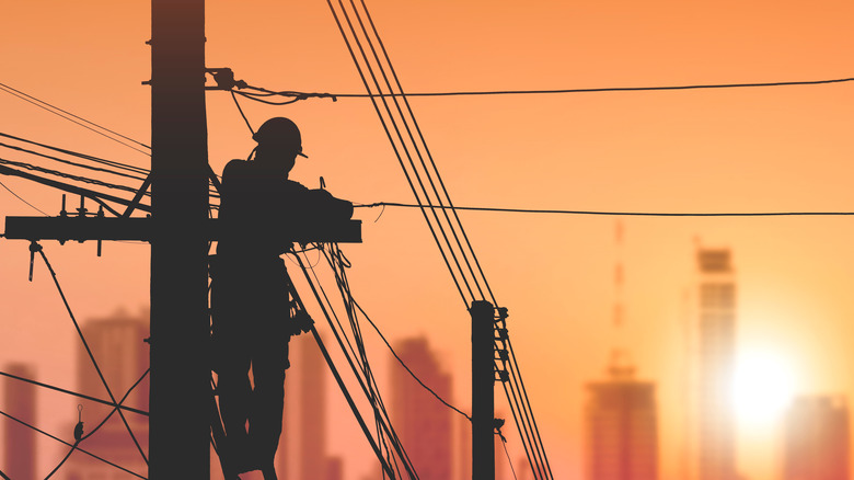 A lineman fixing a powerline
