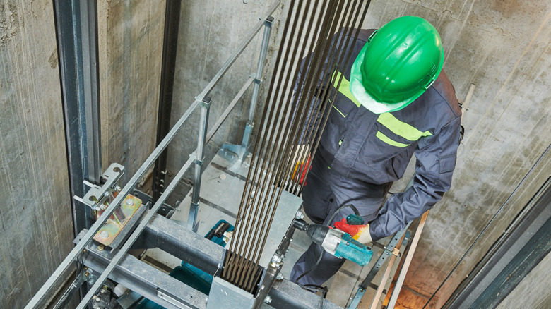 A man repairing an elevator