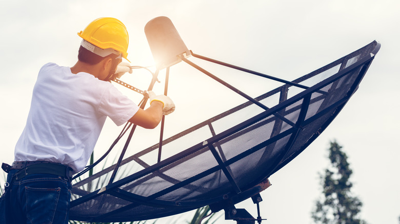 A man installs a satellite