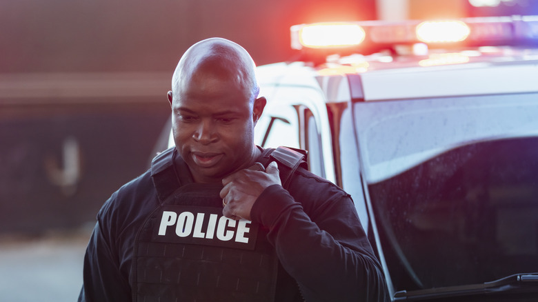 A police officer speaking into a radio