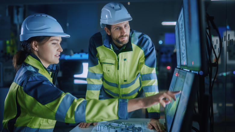 Power plant workers monitoring screens