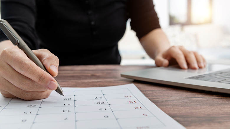 A businesswoman marking a calendar