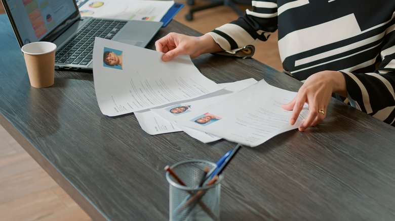 A job recruiter sorting resumes