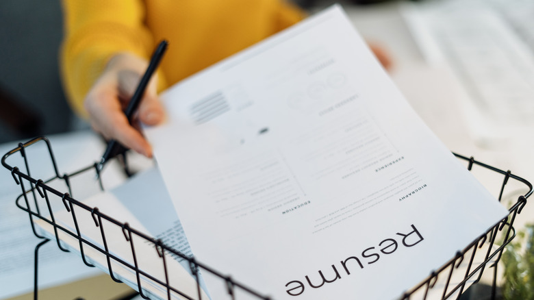 A woman holding a resume
