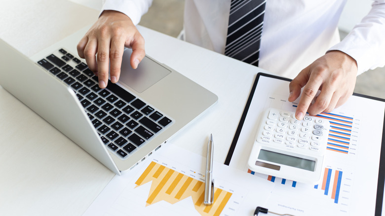 A businessman with a calculator