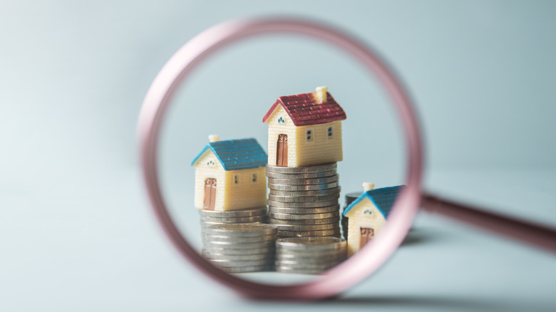 magnifying glass on a house figurine