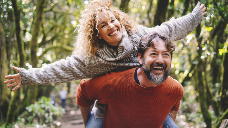Middle-age couple hiking on trail.